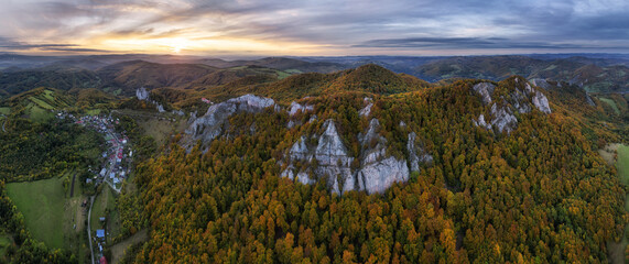 Mountains at sunset in Slovakia - Vrsatec. Landscape with mountain hills orange trees and grass in fall, colorful sky from drone, Aerial Panorama