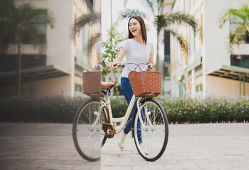 Photo of young Asian woman with bicycle