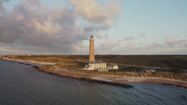 Flying Over The Sea Towards The Skagen Lighthouse (Det Gra Fyr) In Denmark. - aerial approach