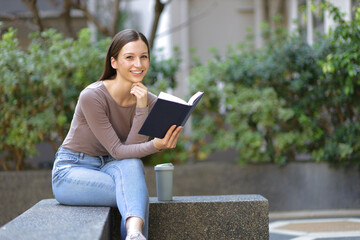 Fototapeta premium Female university students reading textbooks preparing for exams.