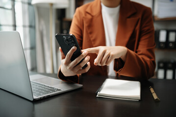 Businesswomen analyzing investment graph and discussing plan new start up project. Finance task...