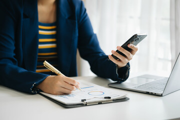 businessman working with digital tablet computer and smart phone with financial business strategy layer effect on desk