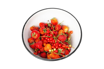 A bowl of berries isolated on a white background. Harvest of strawberries and red currants.