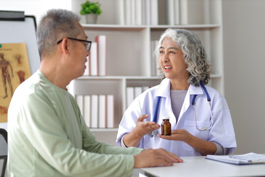 Senior health care concept. Doctor with patient in medical office. The doctor is explaining the medication instructions to the patient.