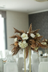 Fototapeta premium Wedding decorations. Wedding event. Decor of the wedding table with fresh flowers and pampas grass