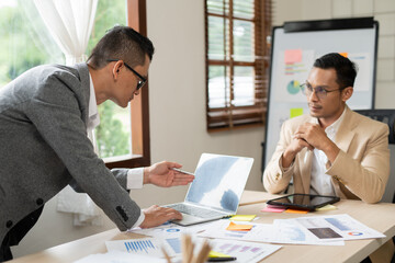 Asian businessmen, women and men Talk about new projects, presents at home office.