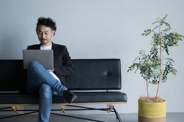Asian male using a computer Freelance or engineer image