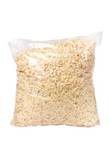 The bag is full of wood shavings. Wood shavings isolated on a white background.