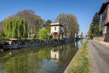 Fototapeta premium Scenic view of Robecco sul Naviglio village along the scenic Naviglio Grande bike path in Lombardia,