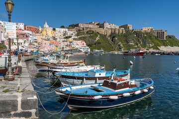 Fototapeta na wymiar Idyllic marina scene of Procida Marina Grande port in Campania, Italy with fishing boats