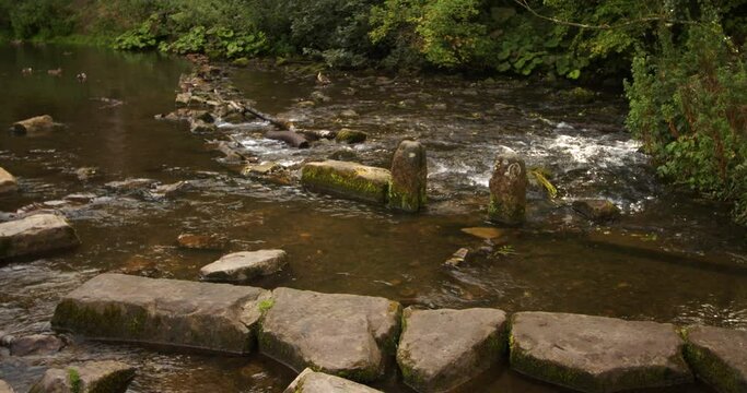 wide shot of disused water mill workings on the river dove