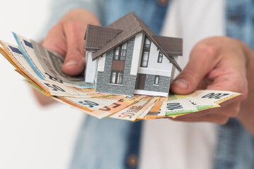Property buyer holding euro banknotes and buying beautiful flat from real estate agencies on...