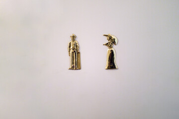 Vintage women and men washroom symbols on the white door
