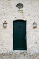 Dark green entrance door in the stone building