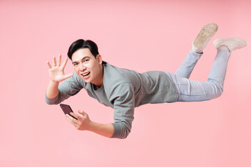 Photo of young Asian man flying on background
