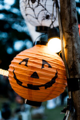 Halloween paper lantern hanging with lights. Holiday decorations for Halloween