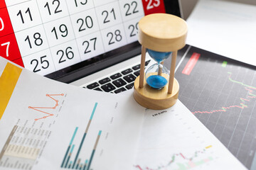 Hour glass on calendar with thumbtacks concept for time slipping away for important appointment...
