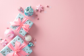 Chic New Year setting. Top-down view of decorations, balls, stars, cute gift boxes tied with ribbons, mistletoe berries on a soft pastel pink backdrop with a blank area for text or promotional content
