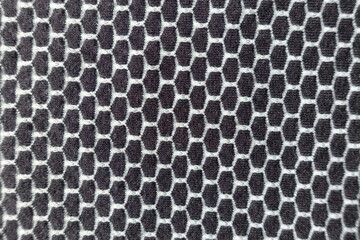 Texture of black and white jersey fabric with honeycomb pattern