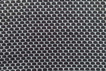 Top view of black and white jersey fabric with honeycomb pattern