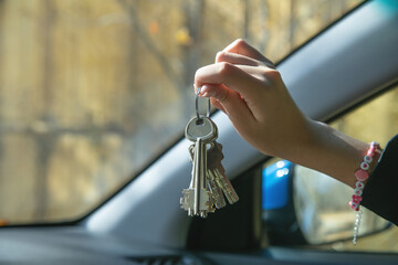 Caucasian female hand showing house keys.