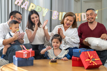 Portrait of happy love asian big family father and mother with asian baby and little girl happy birthday, party, celebration, cake, surprise, grandfather with grandmother smiling together.Family party