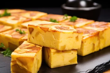 Foto op Canvas close-up of traditional spanish tortilla cut into squares © Alfazet Chronicles