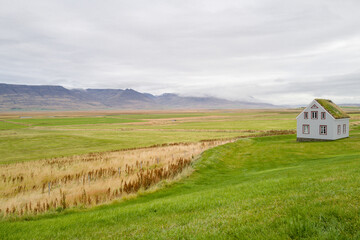 House with green grass on the roof in the countryside landscape in Iceland