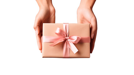 Flat lay of female hands holding a gift wrapped with kraft paper and pink satin ribbon with a bow on a transparent background. Celebrating Valentine's Day, International Women's Day, Mother's Day