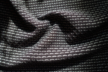 Draped black and white jersey fabric with geometric pattern
