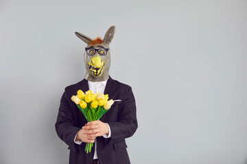 Adult lover man wearing funny strange bizarre silly ugly freak absurd surreal animal donkey mask,...