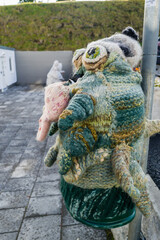 Garbage bin covered with a knitted toy on the street of Akureyri Iceland