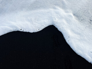 White water foam on the black sand beach in Iceland