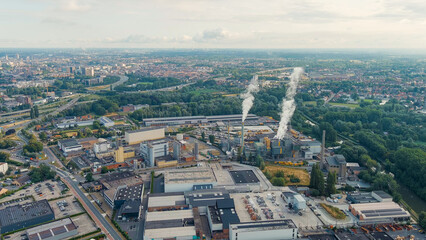 Ghent, Belgium. Factory with chimneys and clouds of smoke in the suburbs of Ghent. River Esco...