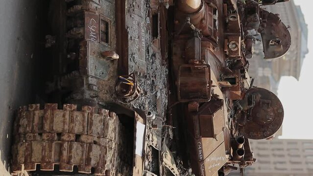 tracks and wheels of a burnt Russian tank. Side view of the tracks of a damaged Russian tank on a city street, Ukraine. The remains of a burnt out and damaged Russian army tank. war in Ukraine