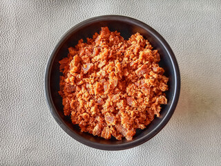 Palm sugar or gula aren. Palm sugar in a bowl. Palm sugar in a bowl on white background. Top view.