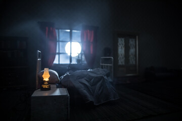 Man comfortably sleeping in his bed at night. A realistic dollhouse bedroom with furniture and window at night. Selective focus - obrazy, fototapety, plakaty