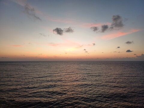 Sunset over the sea in the tropics. Beautiful sky. Photo taken from Cafe on the beach at Ternate Island, Indonesia.