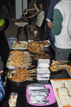 Indian man selling skewers, Kohima Night market, Nagaland, India