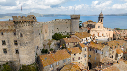 Fototapeta na wymiar Aerial view of the castle and cathedral of Santo Stefano in the historic center of Bracciano, in the metropolitan city of Rome, Italy. The town is located on the shores of Lake Bracciano.