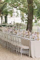 Wedding in classic style. Wedding table in natural tones with luxurious settin, bouquets of roses,