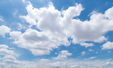 Fototapeta premium Panoramic view of clear blue sky and clouds, Blue sky background with tiny clouds. White fluffy clouds in the blue sky. Captivating stock photo featuring the mesmerizing beauty of the sky and clouds.