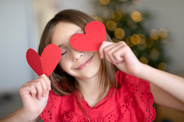 cute girl holding paper hearts, st.Valentines day concept