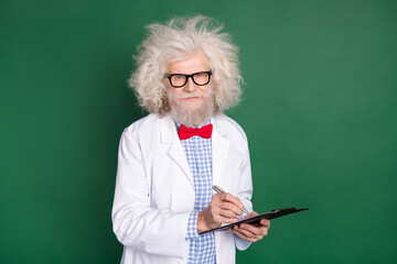 Photo of crazy upset mature inventor dressed white uniform bow tie glasses signing documents...
