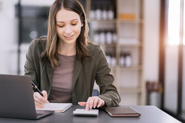 Hand women doing finances and calculate on desk about cost at home office.