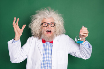 Photo of scared frightened mad crazy scientist screaming failed experiment isolated on green color background