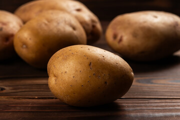 Raw potato food. Fresh potatoes in an old sack on wooden background