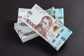a pack of hryvnias on the table. Financial concept. Ukrainian money. 1000 hryvnia on dark background.