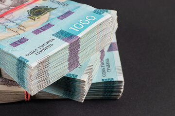 a pack of hryvnias on the table. Financial concept. Ukrainian money. 1000 hryvnia on dark background.