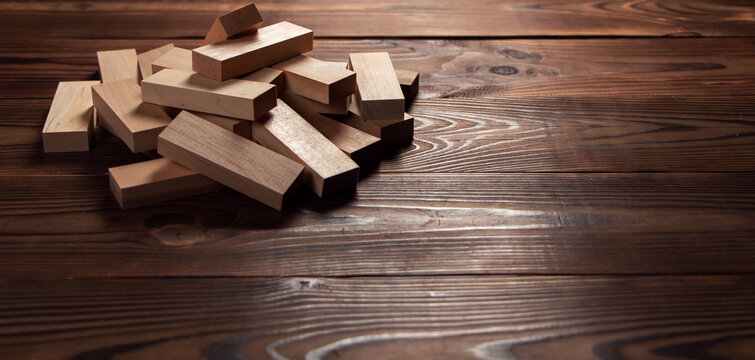 Heap of wooden blocks tower game on wood background